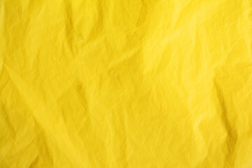 Blank crumpled bright yellow wallpaper background for copy space advertisement.