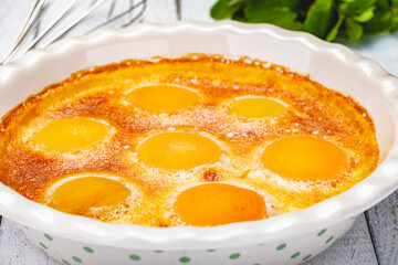 Peach Clafoutis in ceramic pie dish. Close up