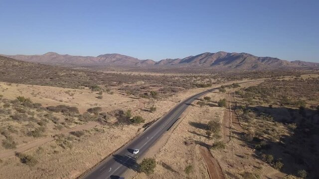 4K aerial drone video of African savanna hills, large red granite boulders range near B1 highway south of Windhoek in central highland Khomas Hochland of Namibia, southern Africa