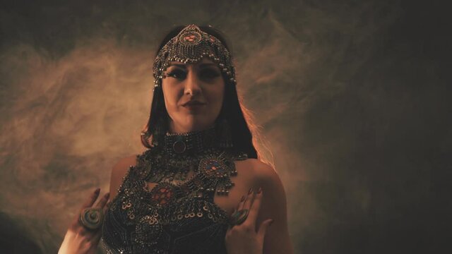 Sensual woman dancing in light and smoke