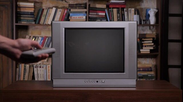 Old Books Background Retro Television Set. Library Room Old Tv Set. 90 Retro Tv Remote Control Screen Close Up. Control Remote Hand Changing Channels Tv Room Interior Home Library Bookshelf Background