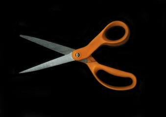 Orange Scissors on a black background. Scan effect