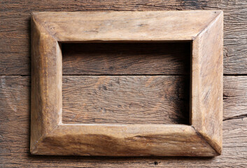 Vintage wooden frame on wood background.