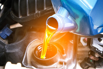 Refueling and pouring oil quality into the engine motor car Transmission and Maintenance Gear .Energy fuel concep