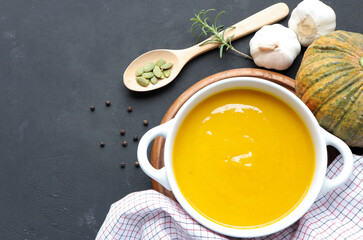 Autumn pumpkin cream soup on the table. Seasonal autumn food.
