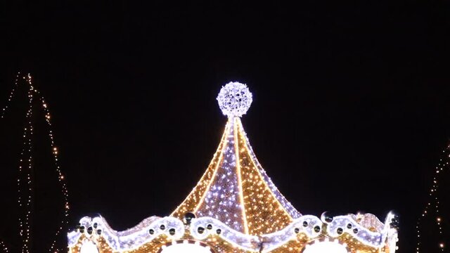 Holiday carousel decorated with garlands. 