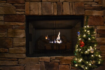Christmas Tree In Front Of Fireplace With Warm Glow