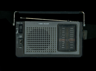 Old portable transistor Radio for emergency broadcasts. Black background. Scan Effect