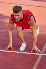 athletic man doing exercises outdoors sports field exercise