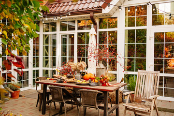 table in the backyard of the house decorated in autumn style. 