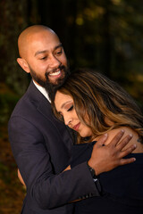 Fototapeta premium Full of love photo of an affectionate mixed race young couple holding each other in the woods