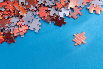 Mixed Peaces of a Colorful Jigsaw Puzzle Lie on the Blue Background - Strategy and Solving Problem Concept