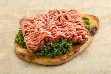 Raw pork minced meat over board