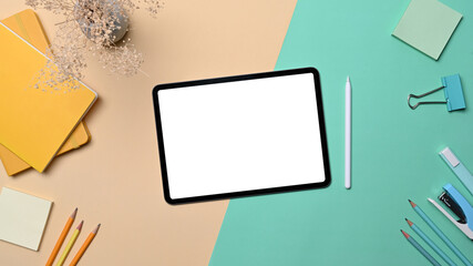 Mock up digital tablet, stylus pen and stationery on colorful background.