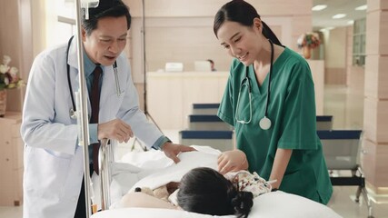 Cute little sick girl patient lying in hospital bed talking with smiling doctor and nurse standing at hospital, Medicine healthcare and pandemic, Friendly doctor concept