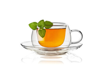Transparent double glass cup with tea and mint leaves on white background. Horizontal. Studio shot. 