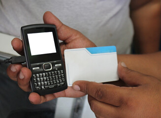 Hands with cell phone and blank card