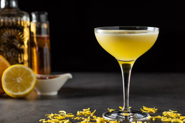 Luxury cocktail and cocktail shaker on black stone background