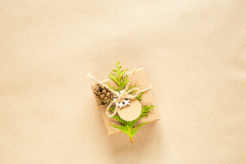 Gift box for Christmas and new year in eco-friendly materials: kraft paper, live fir branches, cones, twine. Tags with mock up, natural decor, hand made, DIY. Flatly, background, frame, Minimalism