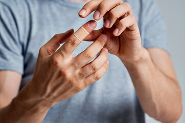 man with bandaged finger help treatment