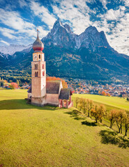 Superb view from flying drone of St. Valentin ( Kastelruth ) church with Petz peak on background. Picturesque autumn scene of Kastelruth village, Province of Bolzano - South Tyrol, Italy..