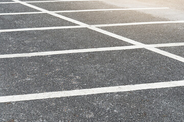White line for separate car park barriers on asphalt road.