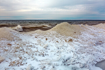 Winter landscape with a river covered with snow and ice hummocks. Ob River, Western Siberia
