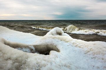 Winter landscape with a river covered with snow and ice hummocks. Ob River, Western Siberia