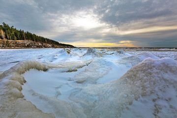 Winter landscape with a river covered with snow and ice hummocks. Western Siberia
