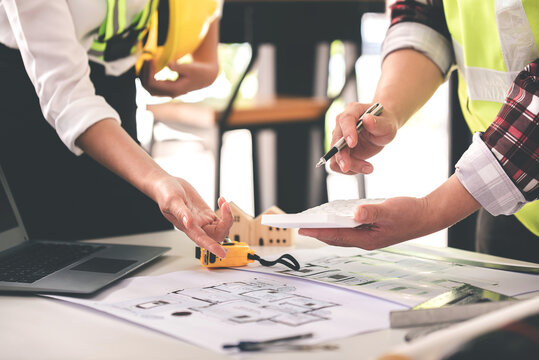 architect concept, working architect with blueprints in office to present to customers