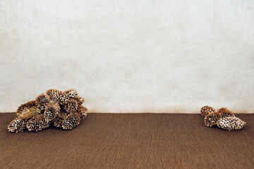 Brown tones. Decorations made of brown paper and cones. Cones isolated on background.