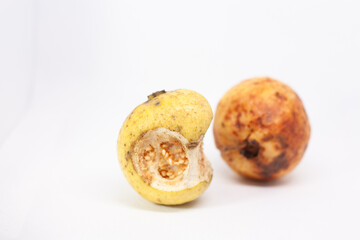 rotten guava on a white background. guava fruit that starts to rot due to being too ripe