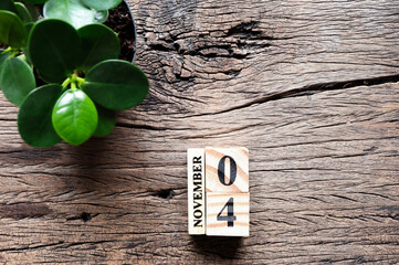 November 4th., Cube wooden calendar showing date on 4 November, Wooden calendar with date and tree on wooden table.