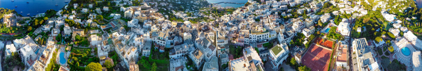 Naklejka premium Aerial view of Capri homes and cityscape at summer sunset, Campania - Italy