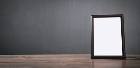 Empty diploma or certificate frame on the table.