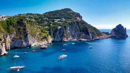 Obraz premium Faraglioni from Marina Piccola Beach in Capri, Italy. Aerial view from drone.