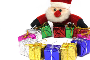 Santa claus doll and Many presents gift box - Xmas or Christmas  concept on white background