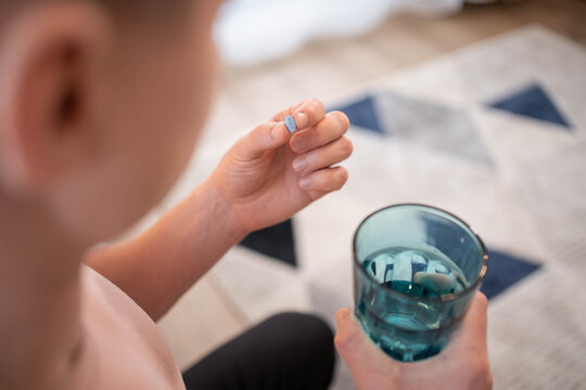 A young man takes a prep in a pill. HIV prevention concept. AIDS prevention concept.