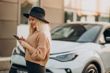 Woman travelling by car and using phone