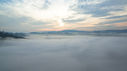 Fototapeta premium aerial view mist above the mountain in tropical rainforest and .beautiful sunrise scenery view in Phang Nga valley.