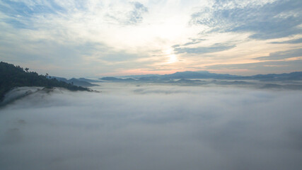 aerial view mist above the mountain in tropical rainforest and .beautiful sunrise scenery view in Phang Nga valley.