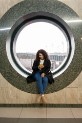 Fototapeta na wymiar Young woman at the railway station