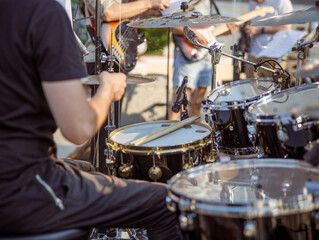 Man drummer having concert rehearsal on the street