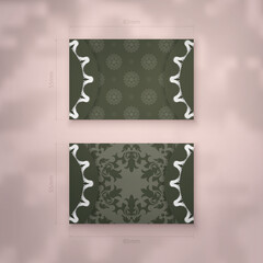 Dark green business card with antique white ornaments for your contacts.