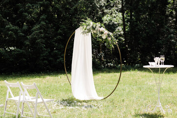 Round wedding arch on a background of trees