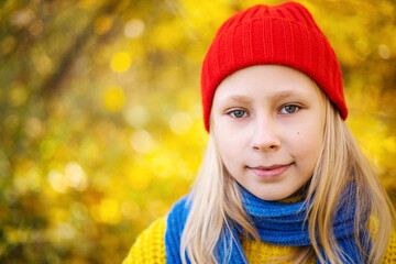 Portrait of a beautiful blonde girl in a yellow sweater
