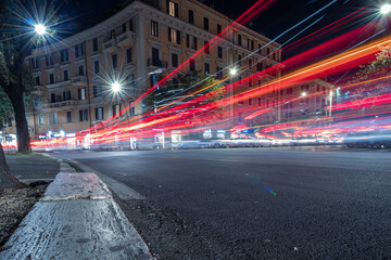 Cool long exposure cars traffic light trails, night view of the city of Rome
