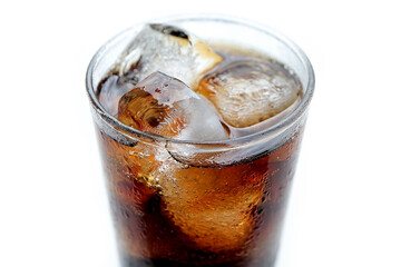 Close-up of Cola drink with Ice and bubbles and water drops on glass. Food background.
