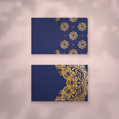 Presentable business card in dark blue with abstract gold ornaments for your personality.
