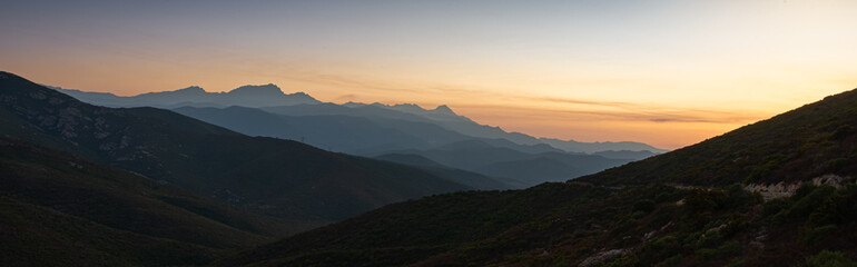 Obraz premium sunset over the corsican mountains near saint florent ,corsica France , soft layered misty colours ,with copy space .